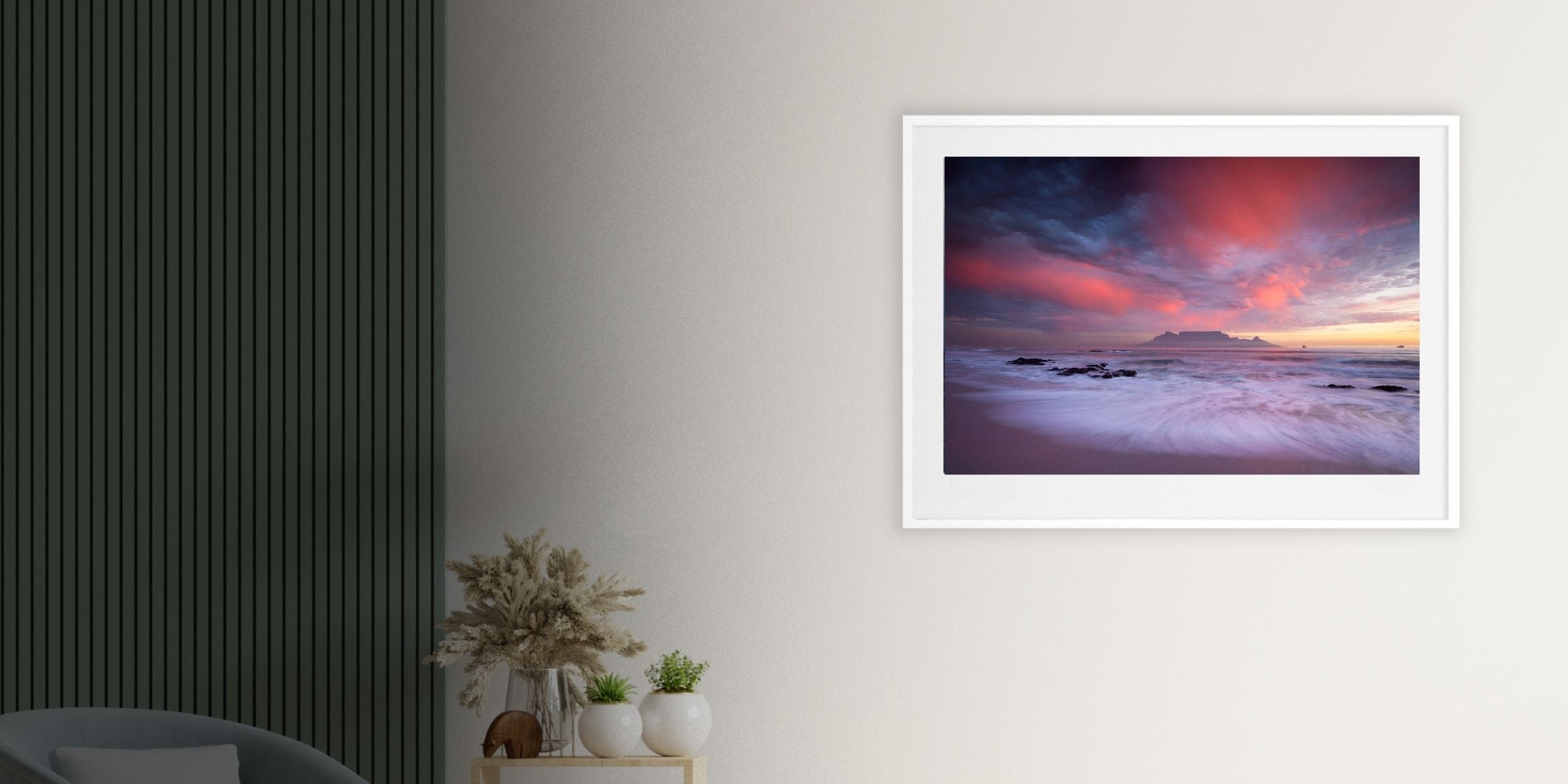 Fine art photograph by Hougaard Malan showing Table Mountain across Table Bay at sunset, with vibrant pink clouds and waves breaking on the shore